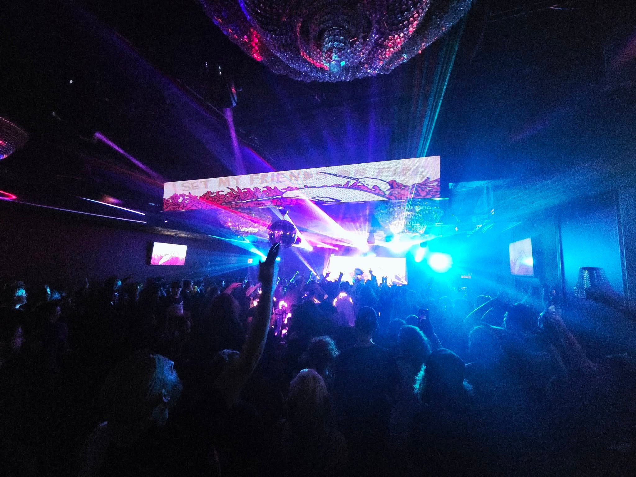 Concert crowd with LED wall and blue and pink lighting at Photo City Music Hall